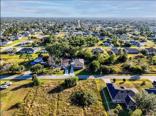 an aerial view of residential houses with outdoor space and swimming pool