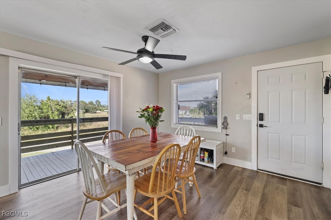 3909 3rd Street Southwest Lehigh Acres, FL 33976 - Photo 5 of 16 a view of a dining room with furniture window and wooden floor