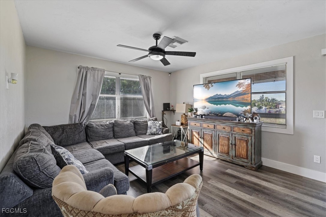 3909 3rd Street Southwest Lehigh Acres, FL 33976 - Photo 7 of 16 a living room with furniture a ceiling fan and a window
