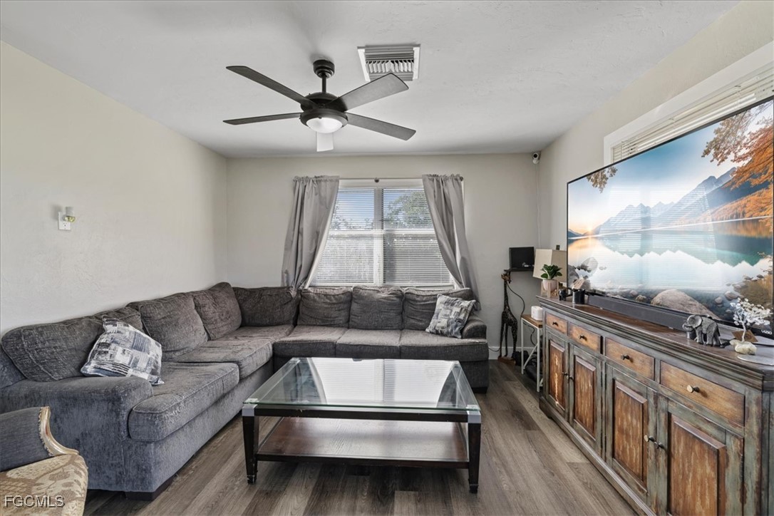 3909 3rd Street Southwest Lehigh Acres, FL 33976 - Photo 8 of 16 a living room with furniture and a wooden floor