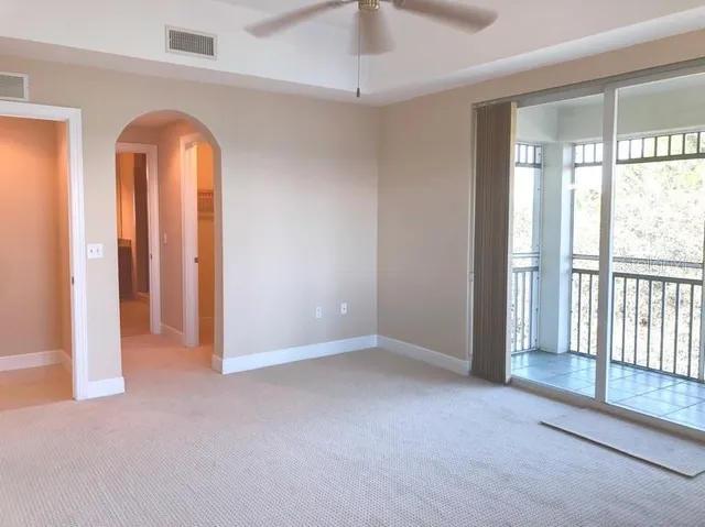 an empty room with windows and closet