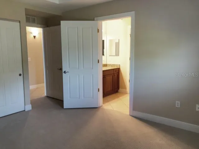 an empty room with windows and bathroom