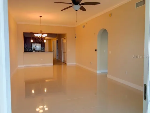 a room with a chandelier and a ceiling fan