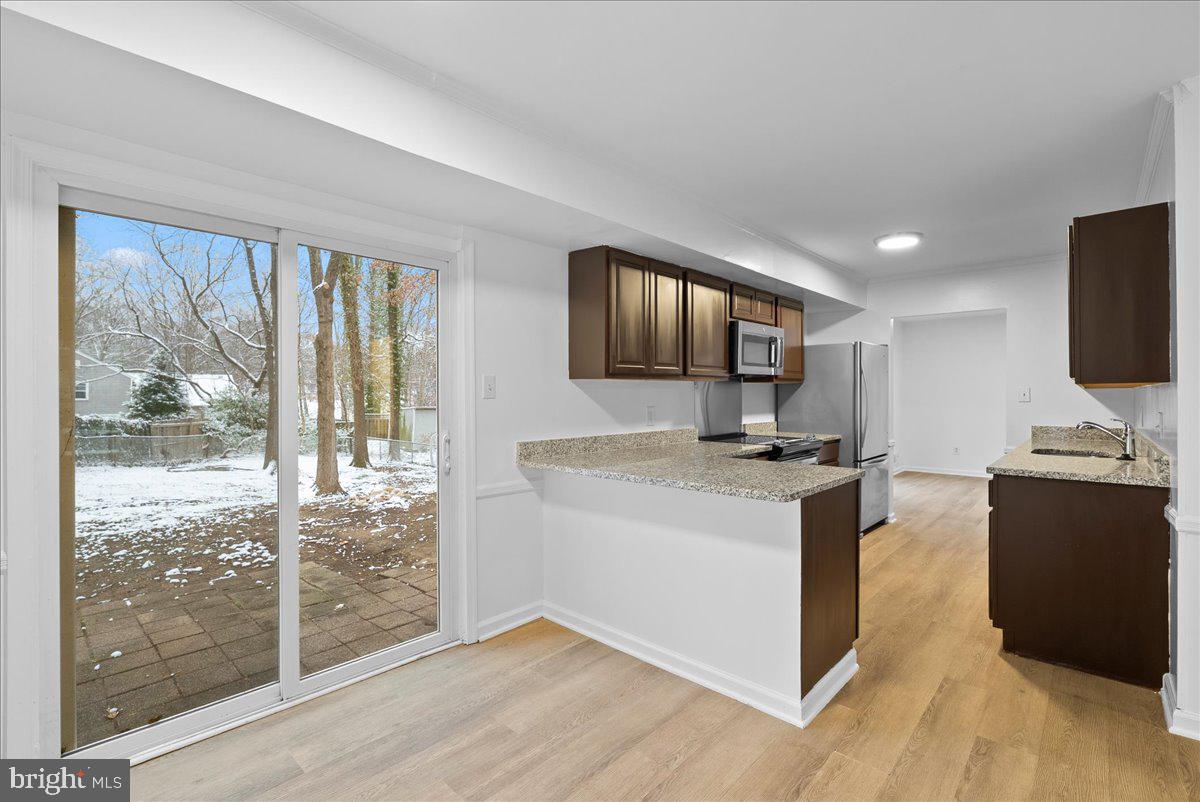 8608 Greeley Boulevard Springfield, VA 22152 - Photo 11 of 34 a kitchen with stainless steel appliances granite countertop a stove and a sink