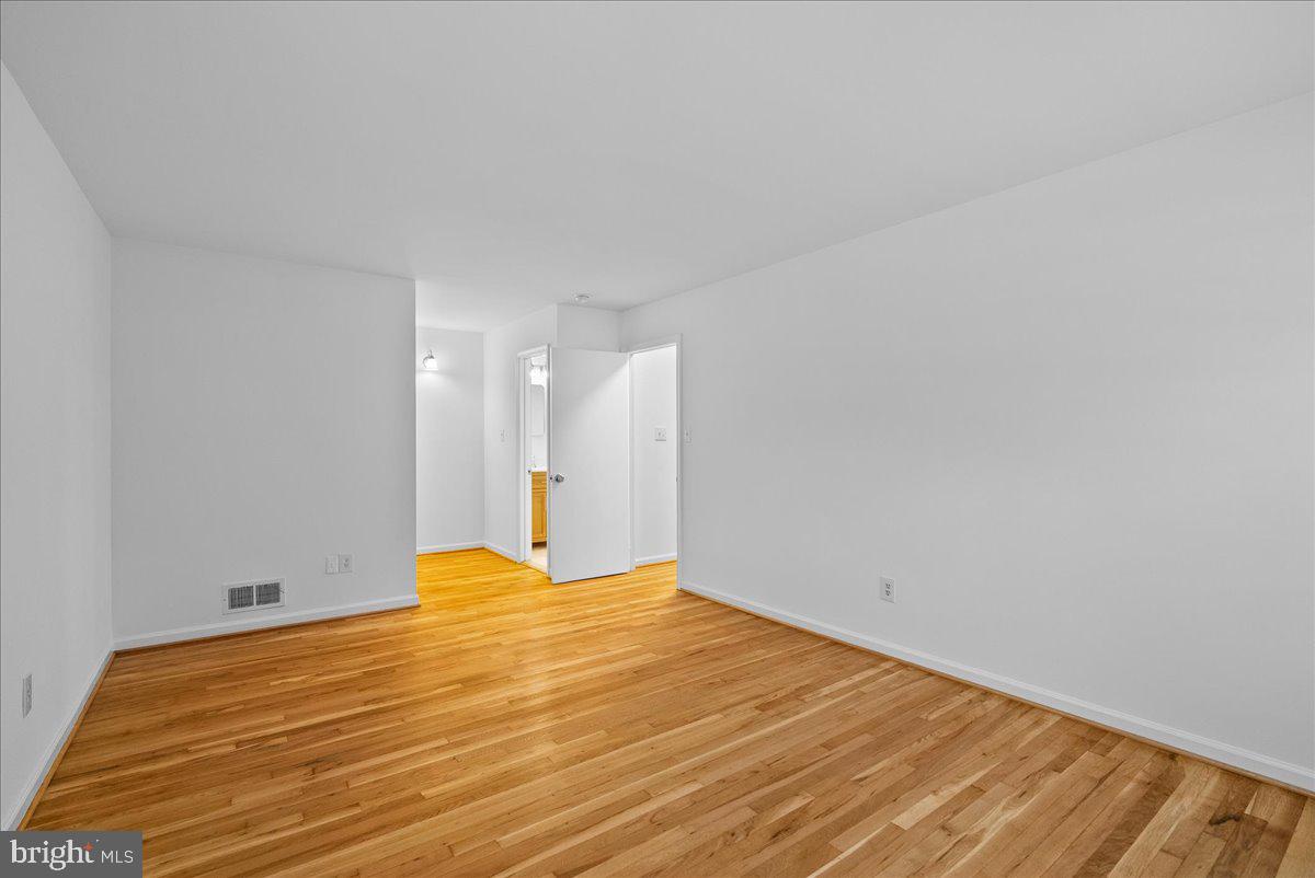 8608 Greeley Boulevard Springfield, VA 22152 - Photo 16 of 34 a view of empty room with wooden floor