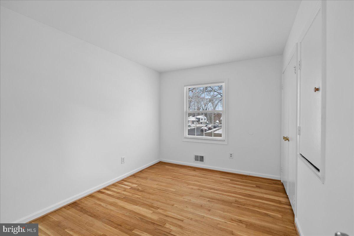 8608 Greeley Boulevard Springfield, VA 22152 - Photo 19 of 34 a view of empty room with wooden floor