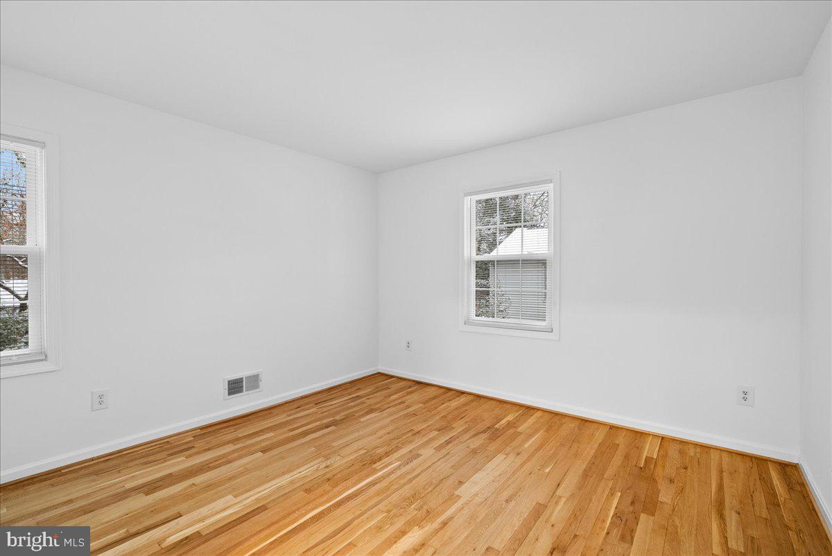 8608 Greeley Boulevard Springfield, VA 22152 - Photo 22 of 34 a view of empty room with wooden floor and fan