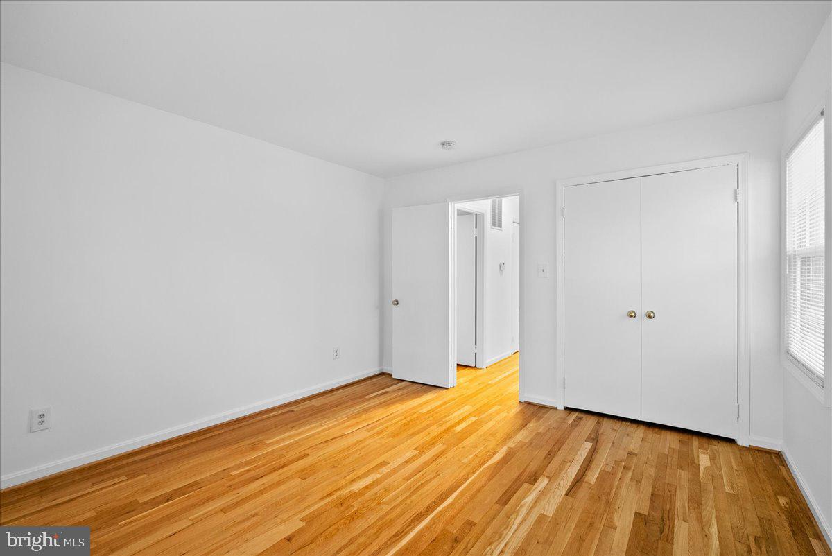 8608 Greeley Boulevard Springfield, VA 22152 - Photo 23 of 34 a view of a room with wooden floor and white walls