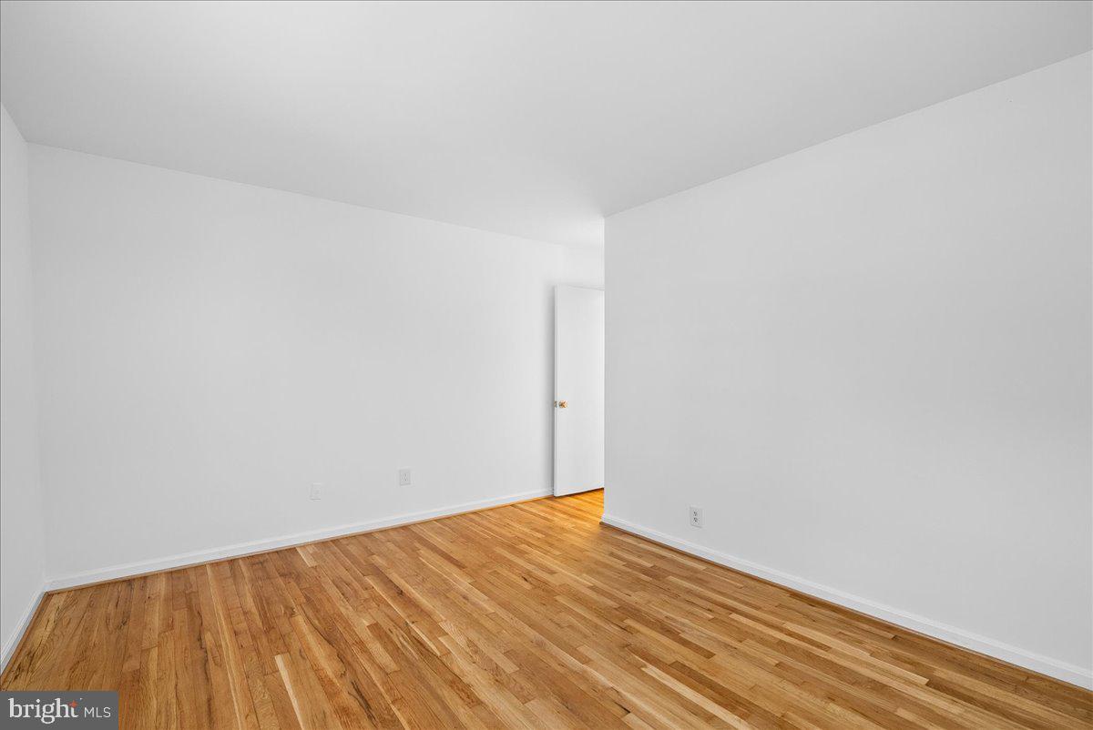8608 Greeley Boulevard Springfield, VA 22152 - Photo 25 of 34 a view of empty room with wooden floor