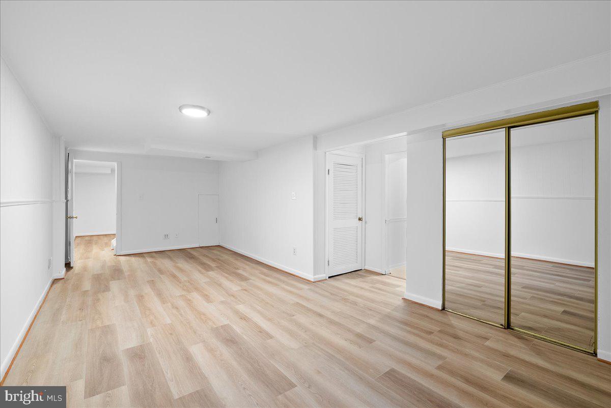 8608 Greeley Boulevard Springfield, VA 22152 - Photo 29 of 34 a view of an empty room and wooden floor