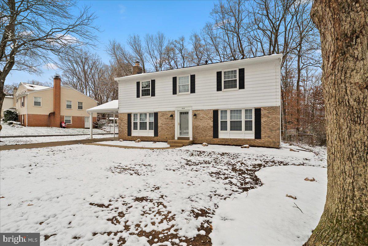 8608 Greeley Boulevard Springfield, VA 22152 - Photo 3 of 34 a front view of a house with a yard