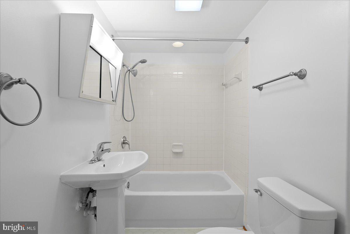 8608 Greeley Boulevard Springfield, VA 22152 - Photo 31 of 34 a bathroom with a sink a toilet and shower