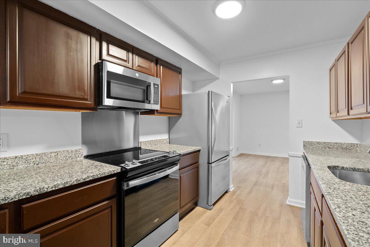 8608 Greeley Boulevard Springfield, VA 22152 - Photo 8 of 34 a kitchen with stainless steel appliances granite countertop a stove and a microwave