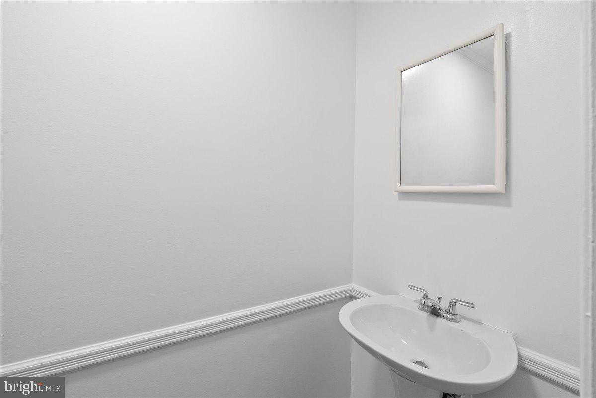 8608 Greeley Boulevard Springfield, VA 22152 - Photo 9 of 34 a bathroom with a sink and a mirror