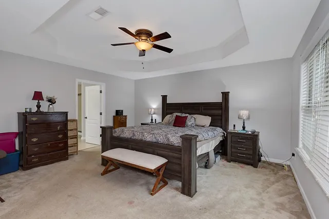 a bedroom with a bed and a chandelier