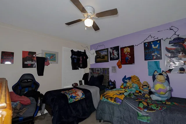 a bedroom with bed and a chandelier