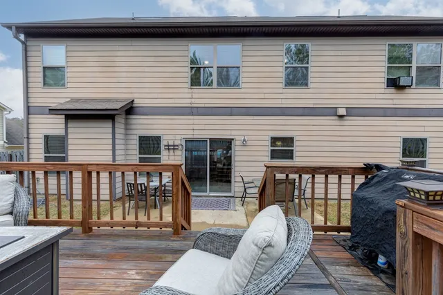 a view of backyard with deck and wooden floor