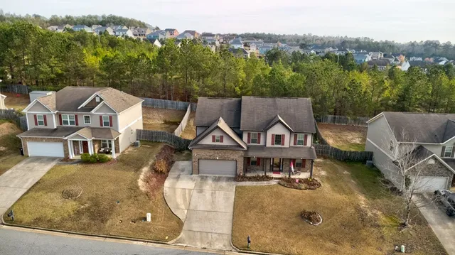 an aerial view of a house with a big yard