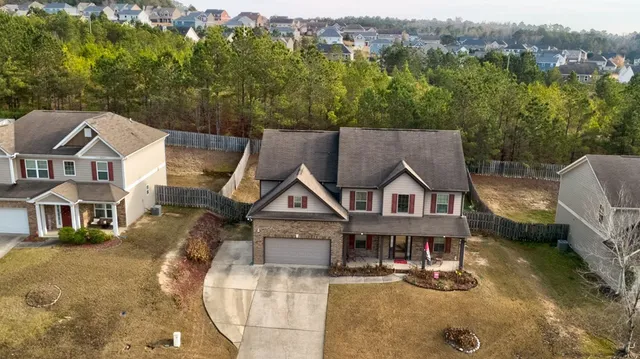 an aerial view of a house with swimming pool and sitting space