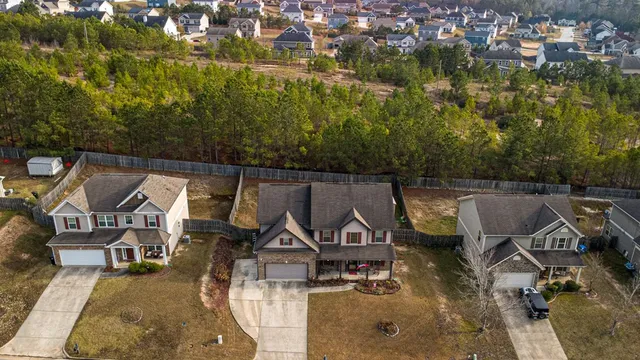 a aerial view of a house with swimming pool and large trees
