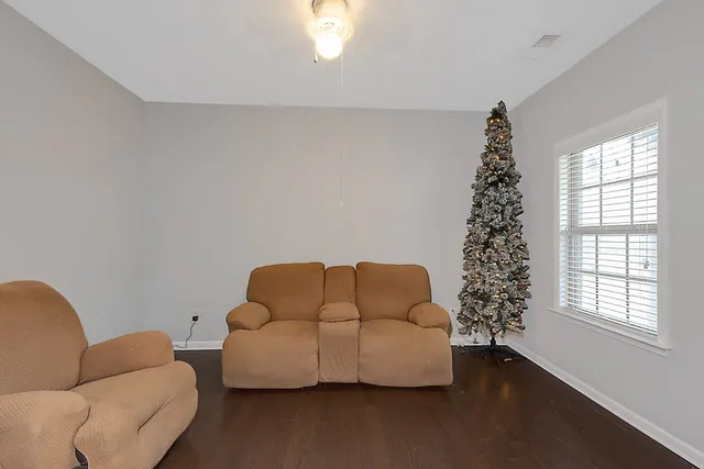 a living room with furniture a couch and a window