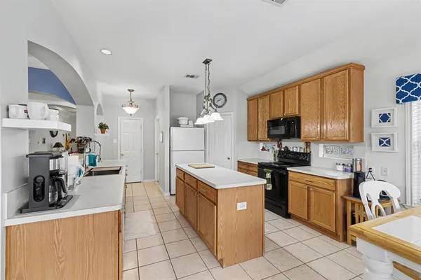 a kitchen that has a lot of cabinets in it and appliances