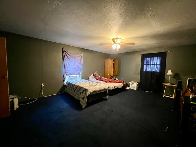 a bedroom with a bed dresser and a window