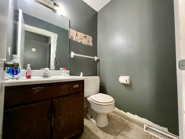 a bathroom with a sink toilet and mirror
