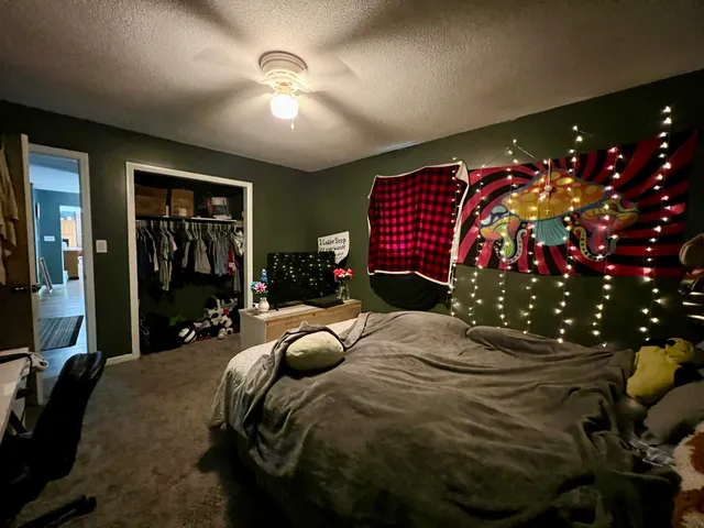 a bedroom with bed and a chandelier