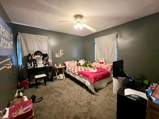 a bedroom with bed and a chandelier