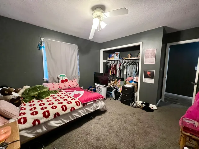 a bedroom with bed and a window