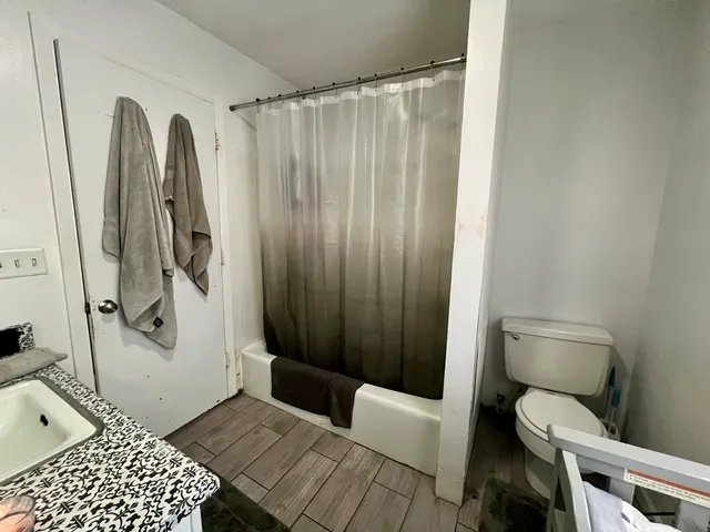 a bathroom with a toilet and a shower