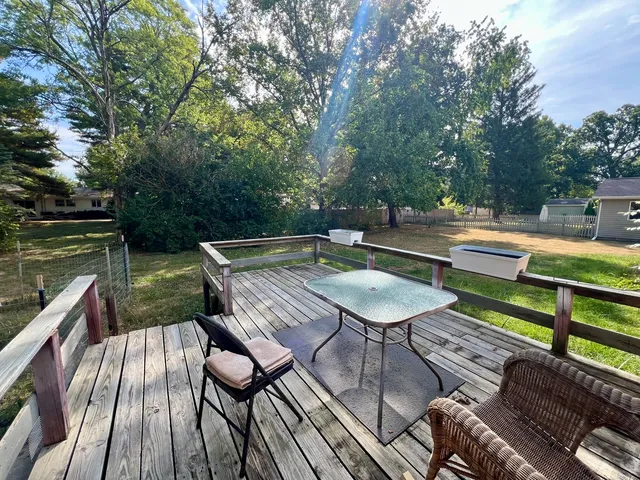 a backyard view with a seating space