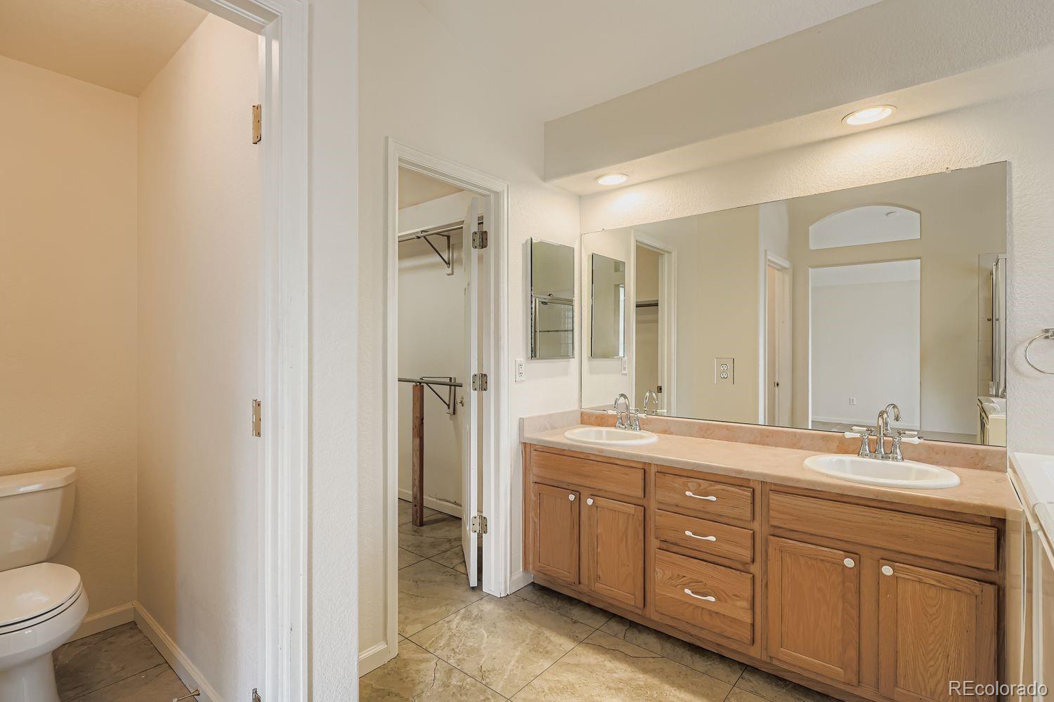 13637 Wamblee Trail Conifer, CO 80433 - Photo 14 of 30 a spacious bathroom with a double vanity sink mirror double and shower