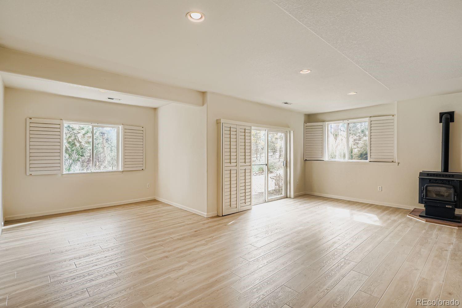 13637 Wamblee Trail Conifer, CO 80433 - Photo 21 of 30 a view of an empty room with wooden floor and a window