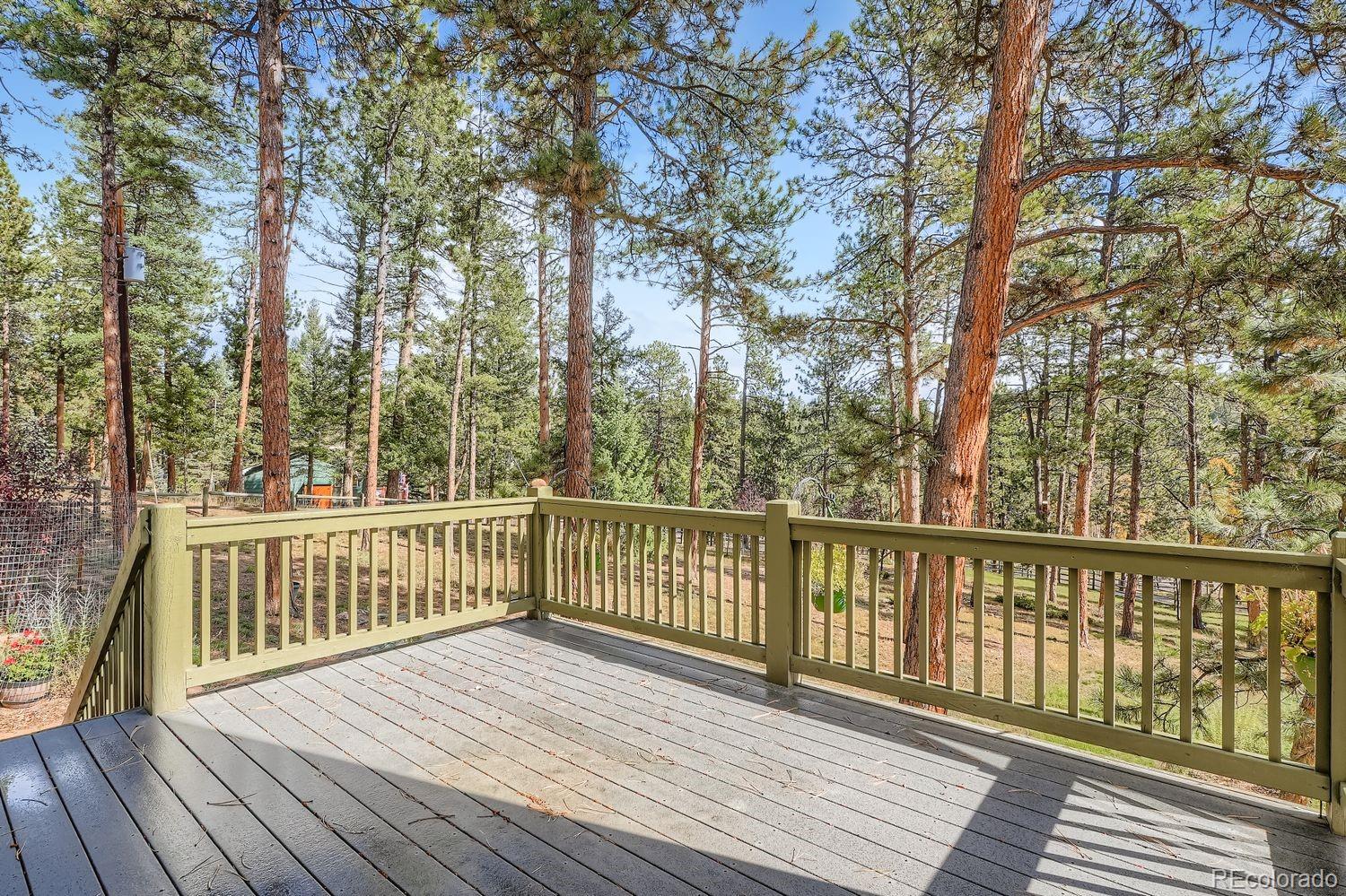 13637 Wamblee Trail Conifer, CO 80433 - Photo 25 of 30 a view of deck with wooden floor and fence