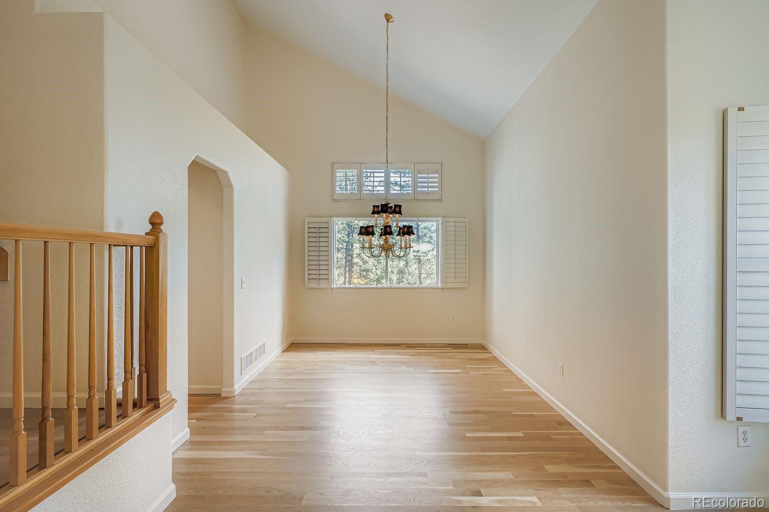 13637 Wamblee Trail Conifer, CO 80433 - Photo 5 of 30 a view of a hallway with windows and chandelier