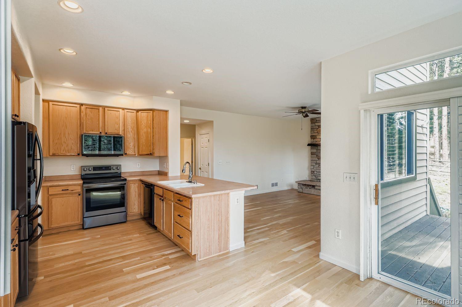13637 Wamblee Trail Conifer, CO 80433 - Photo 8 of 30 a kitchen with a refrigerator stove top oven and sink