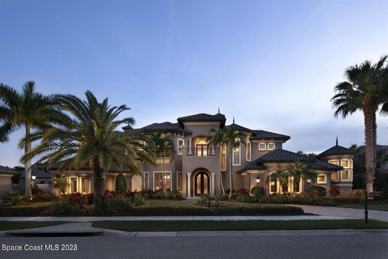 a front view of multiple houses with yard