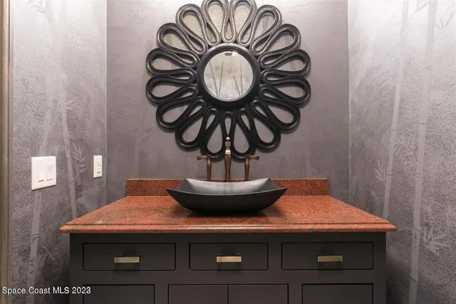 a kitchen with stainless steel appliances granite countertop a stove a sink a refrigerator and a fireplace