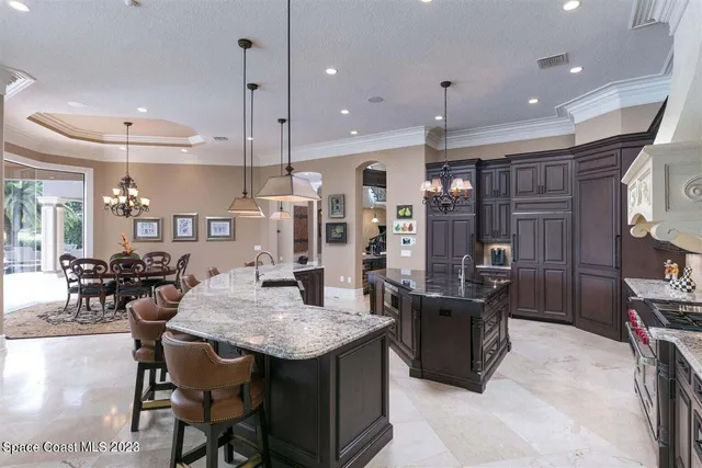 a view of a dining room with furniture and a chandelier