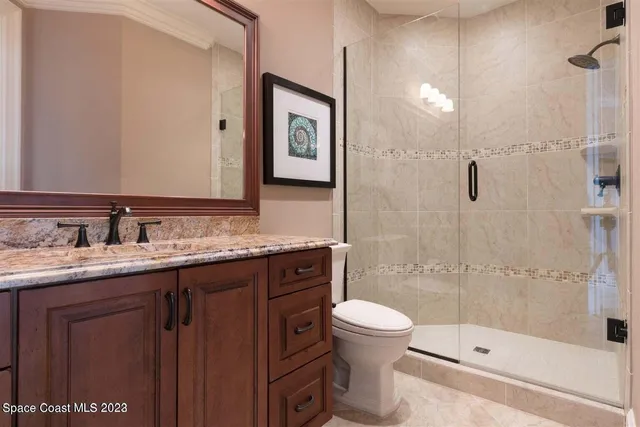 a utility room with granite countertop a sink a washer and dryer next to a window