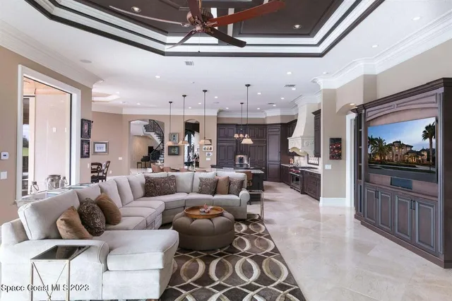 a living room with furniture and a kitchen