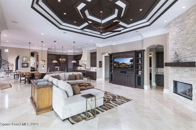 a living room with furniture and kitchen