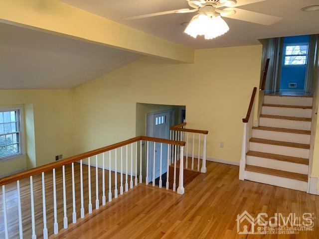45 Meyer Road Edison, NJ 08817 - Photo 4 of 11 a view of a hallway with wooden floor and staircase