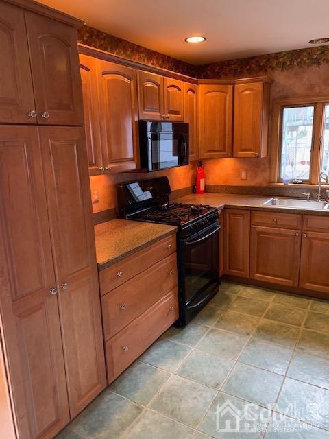 45 Meyer Road Edison, NJ 08817 - Photo 5 of 11 a kitchen with stainless steel appliances granite countertop a stove a sink and a microwave