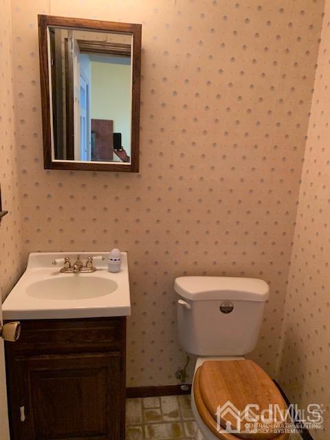 45 Meyer Road Edison, NJ 08817 - Photo 7 of 11 a bathroom with a toilet a sink and mirror