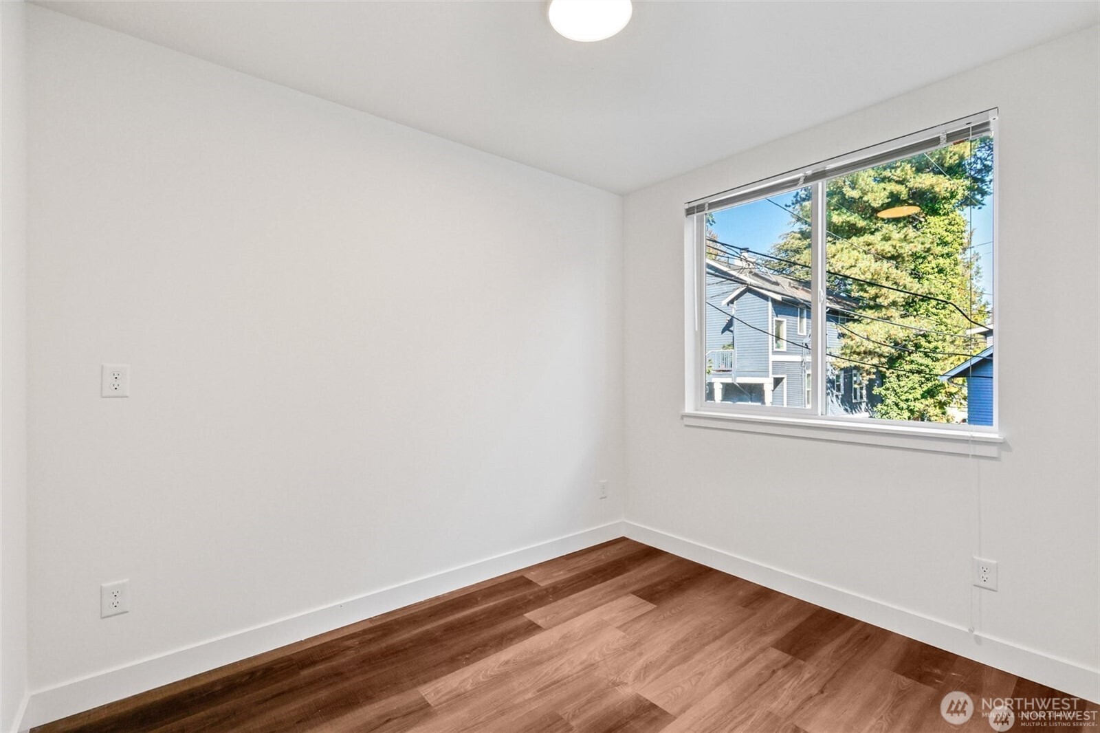 5259 Brooklyn Avenue Northeast Seattle, WA 98105 - Photo 11 of 40 a view of an empty room with wooden floor and a window