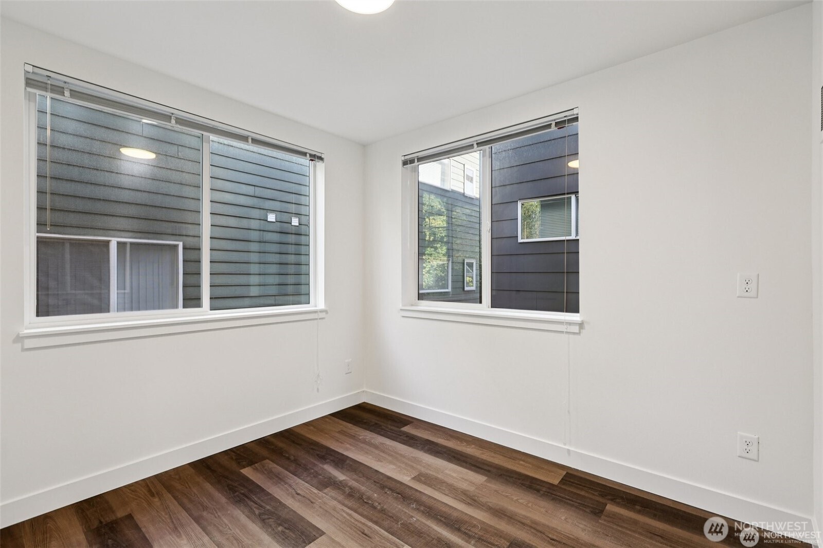 5259 Brooklyn Avenue Northeast Seattle, WA 98105 - Photo 13 of 40 a view of an empty room with wooden floor and a window