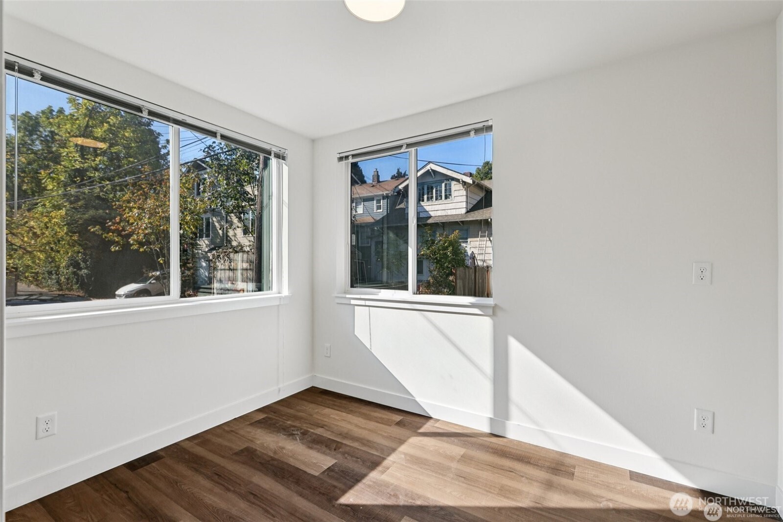 5259 Brooklyn Avenue Northeast Seattle, WA 98105 - Photo 15 of 40 a view of an empty room with wooden floor and a window